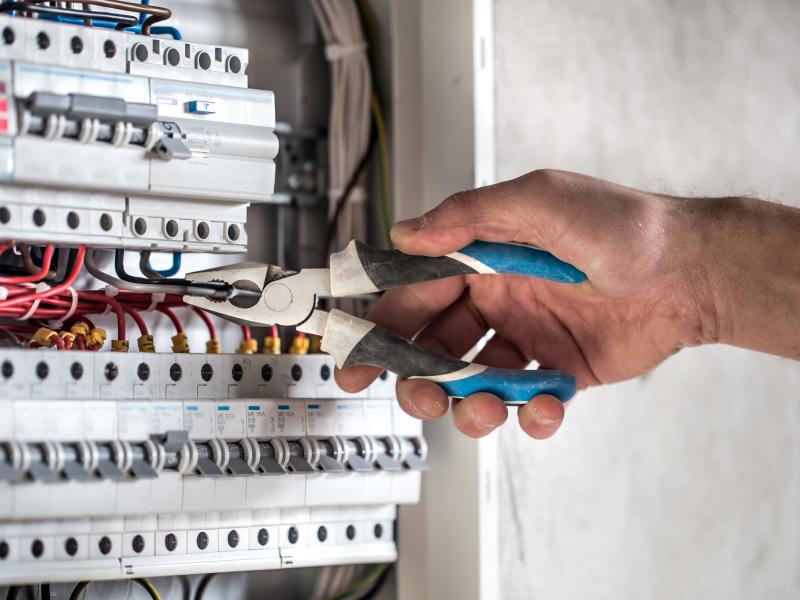 electrical technician working switchboard with fuses3